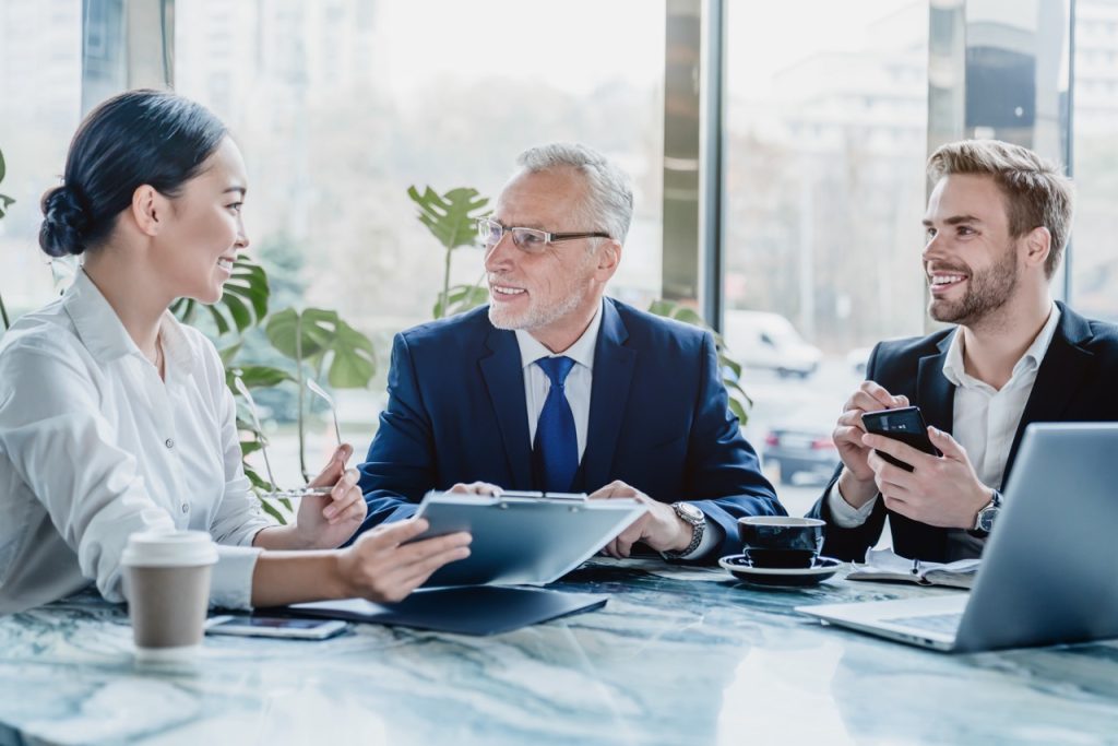 A diverse group of dedicated legal secretaries in a California law office collaborating on a complex project, showcasing teamwork and effective communication